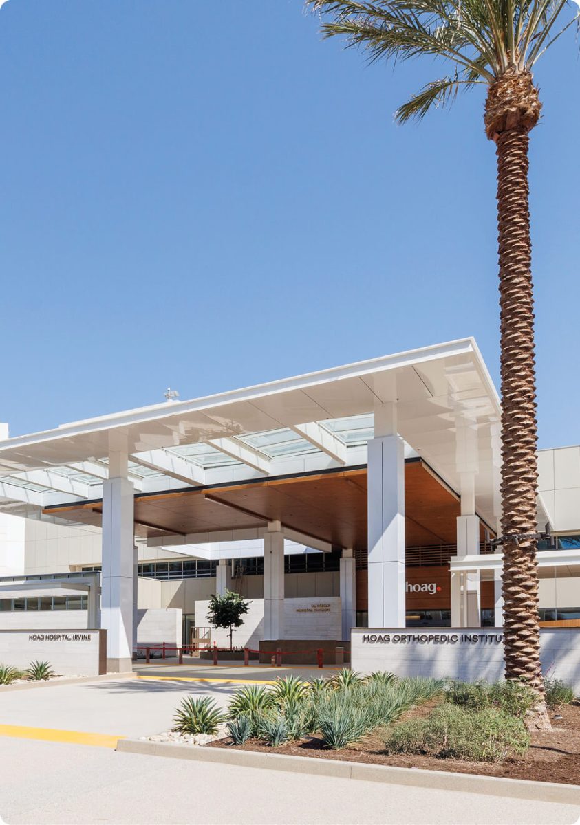 front entry to hospital with white and glass roof